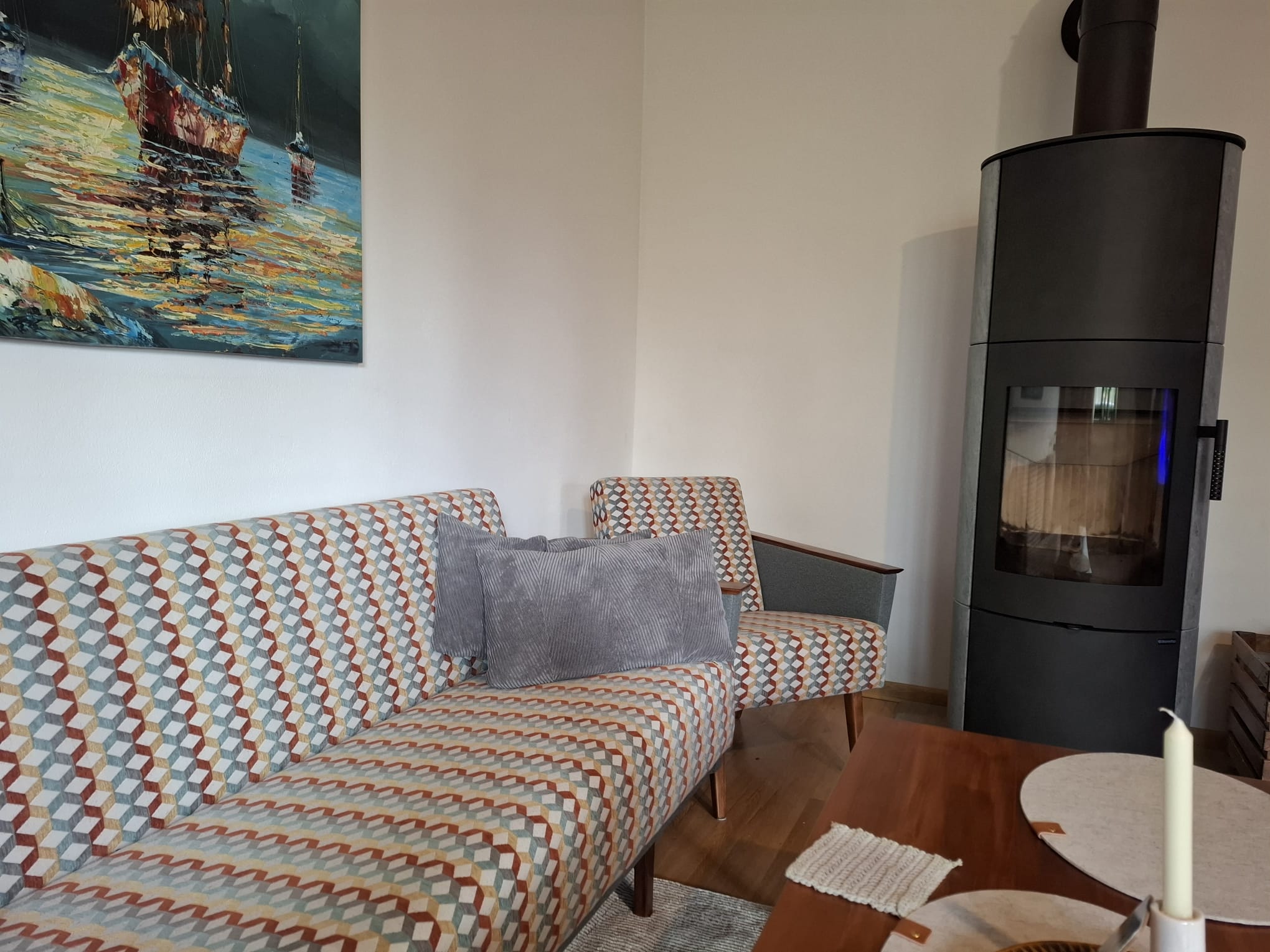 Čalúnenie retro sedačky a kresiel doladené do moderného interiéru s krbom